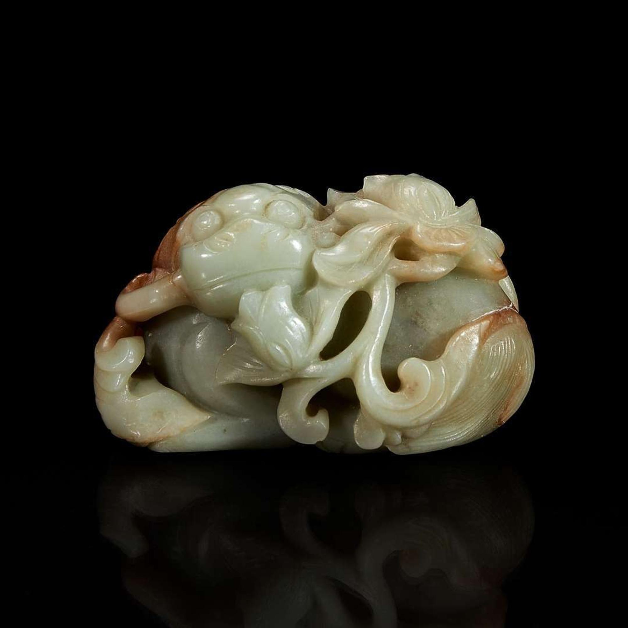A Chinese greyish-celadon and russet jade recumbent beast and lotus group 青玉雕瑞兽衔荷花 18th century or earlier ???????