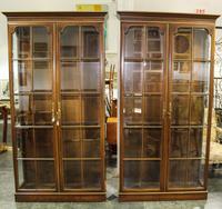 A Pair of Parcel Gilt Vitrine Cabinets Height 85 x width 44 x depth 13 3/4 inches. — 20TH CENTURY