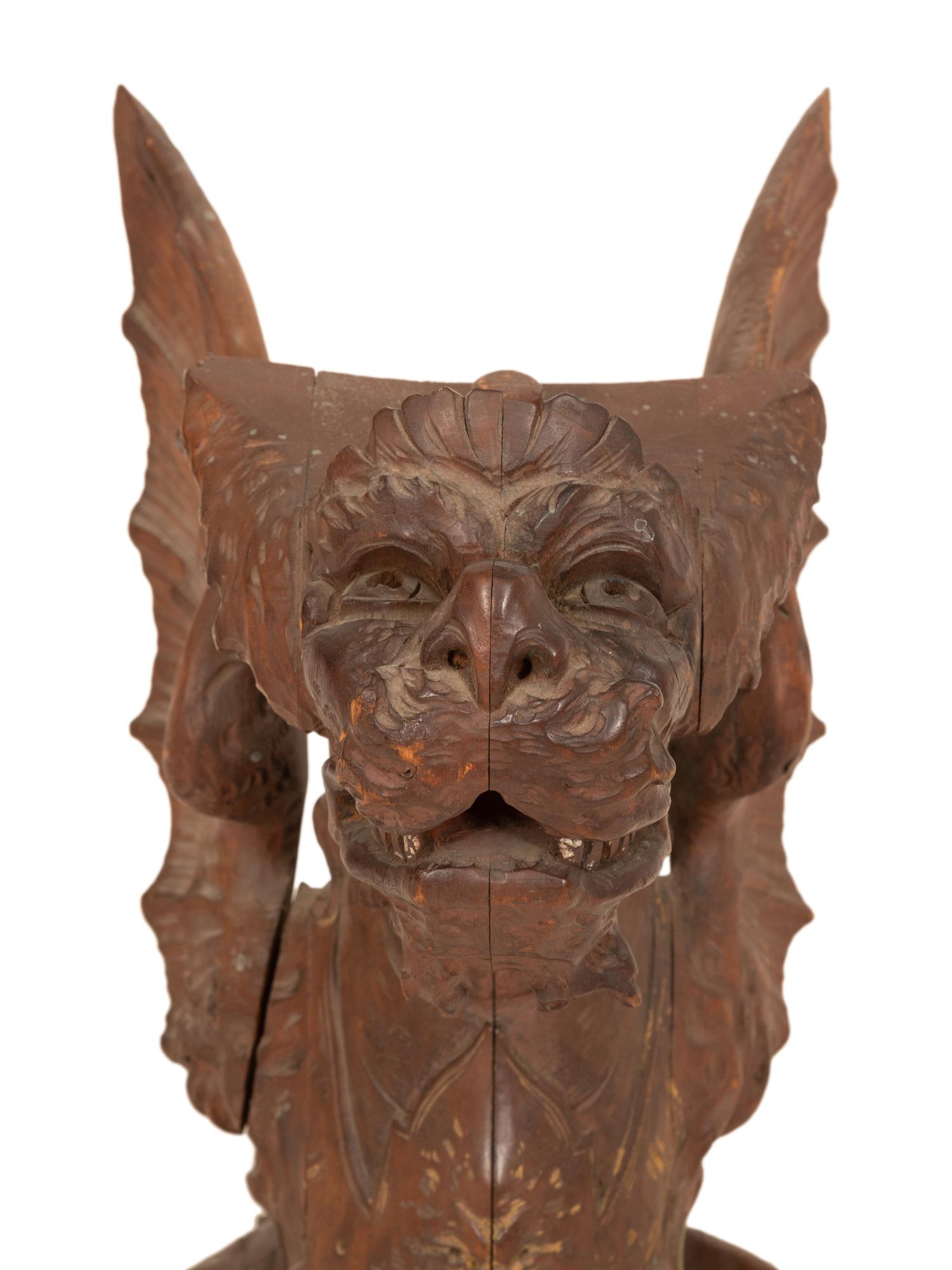 An Italian Carved and Polychromed Seated Dragon