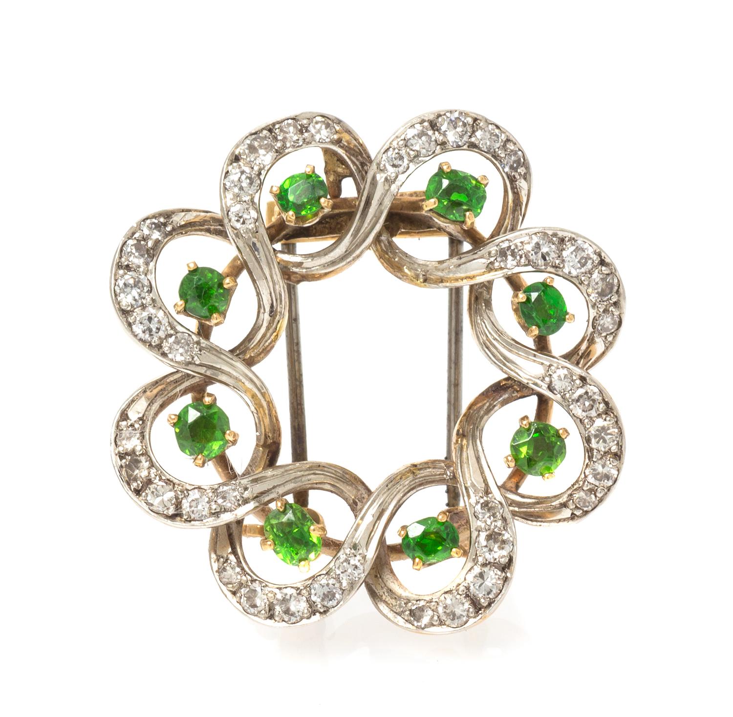 An Edwardian Platinum Topped Gold, Demantoid Garnet and Diamond Pendant/Brooch, Seaman Schepps, 6.40 dwts.