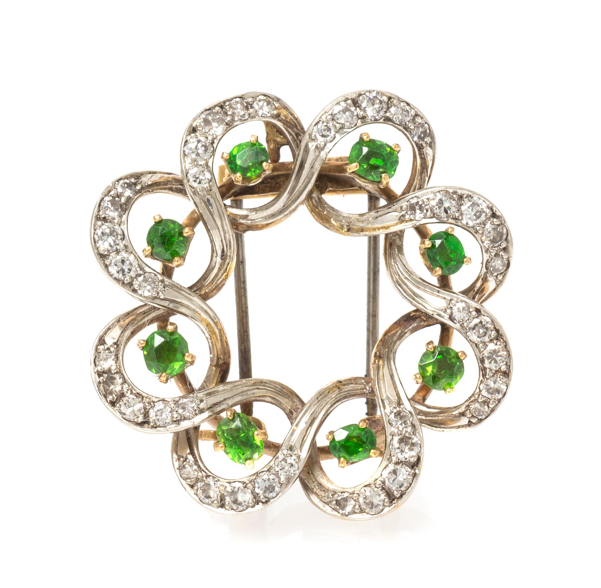 An Edwardian Platinum Topped Gold, Demantoid Garnet and Diamond Pendant/Brooch, Seaman Schepps, 6.40 dwts.