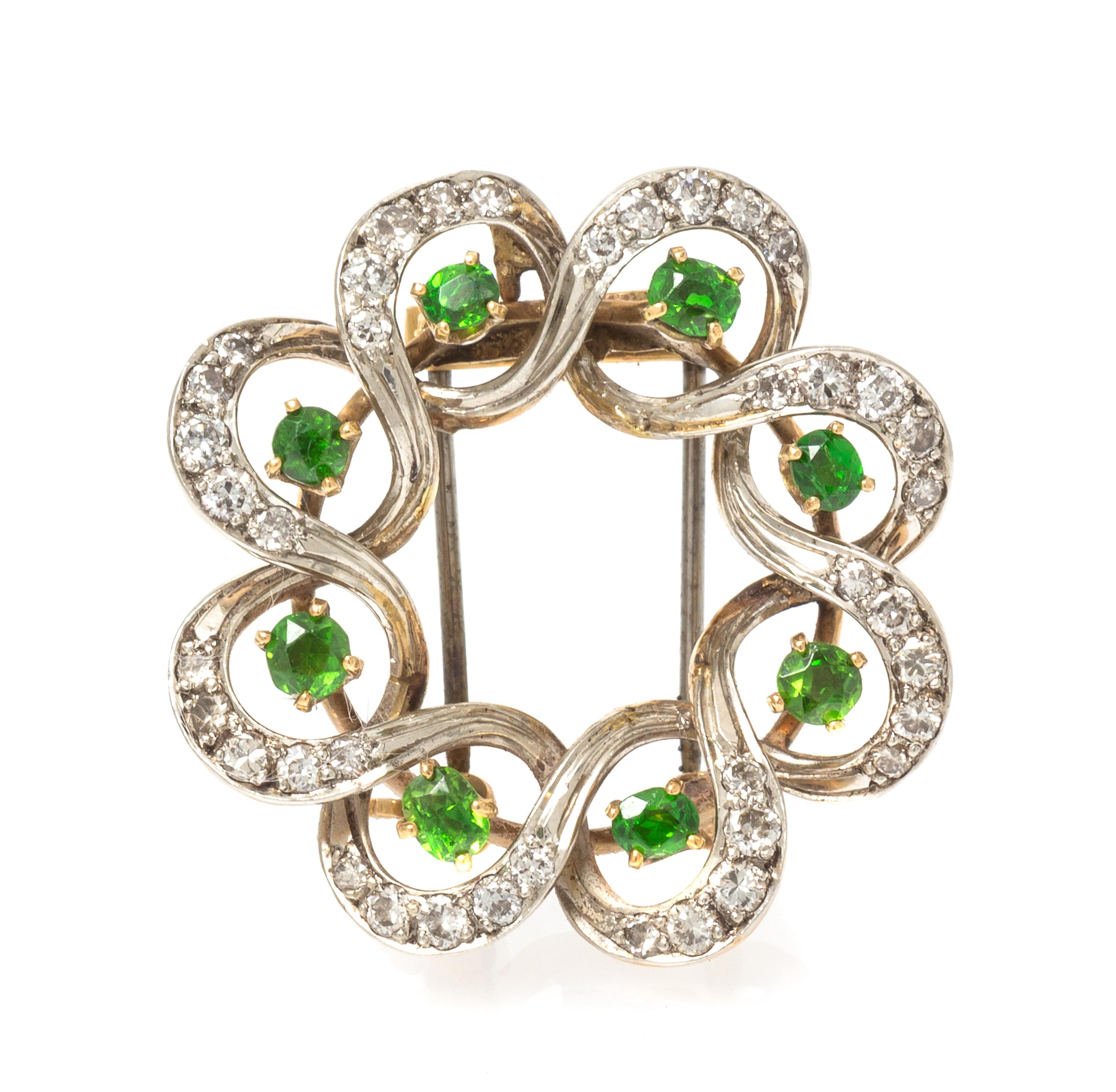 An Edwardian Platinum Topped Gold, Demantoid Garnet and Diamond Pendant/Brooch, Seaman Schepps, 6.40 dwts.