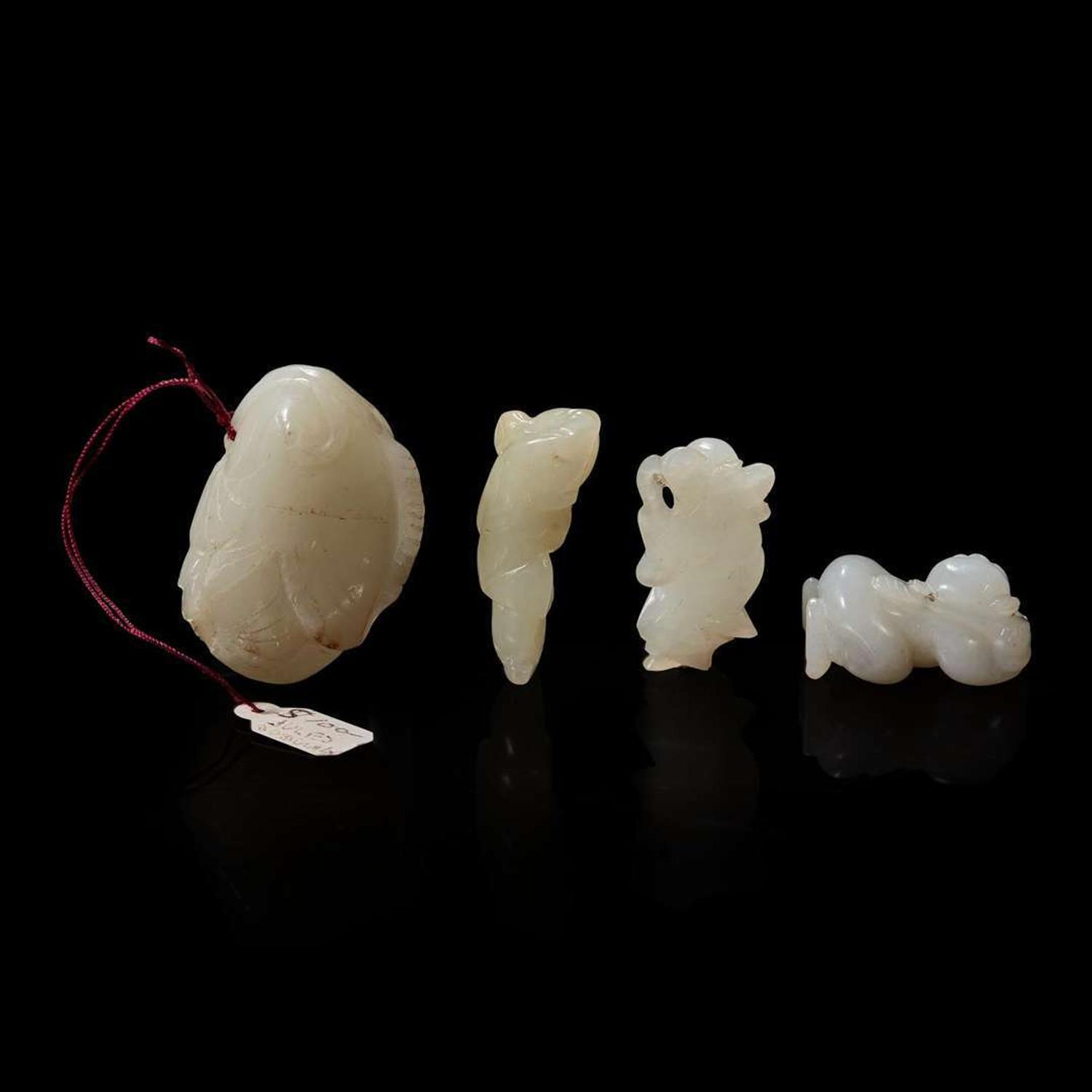 Group of four assorted small white jade figural pendants