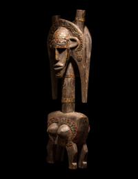 A Bamana Wood Marionette Figure with Eight Wood Puppet Heads