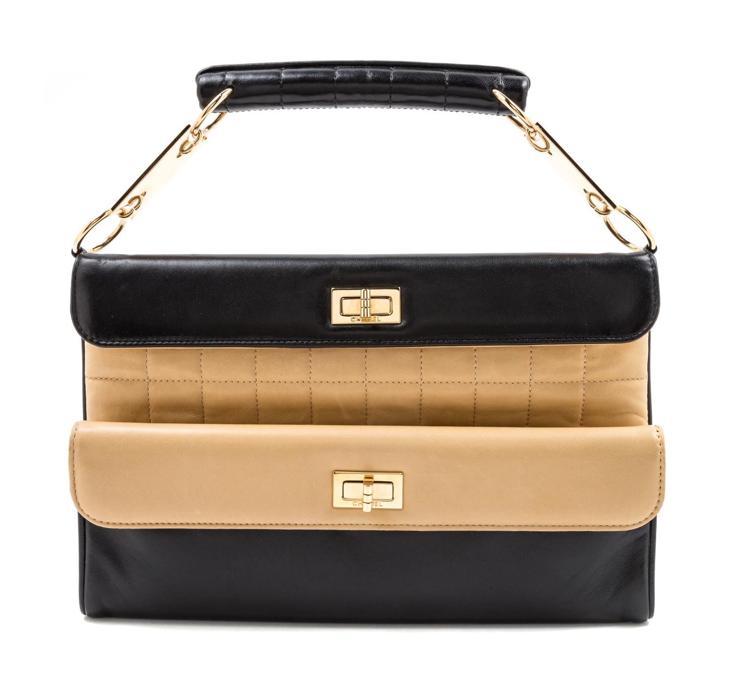 A Chanel Black and Tan Leather Handbag, 7" x 11" x 1"; Top handle 3.5''.