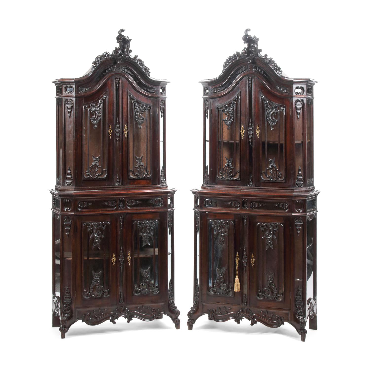 A Pair of Continental Rococo Style Carved Mahogany Vitrine Cabinets