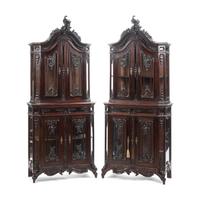 A Pair of Continental Rococo Style Carved Mahogany Vitrine Cabinets
