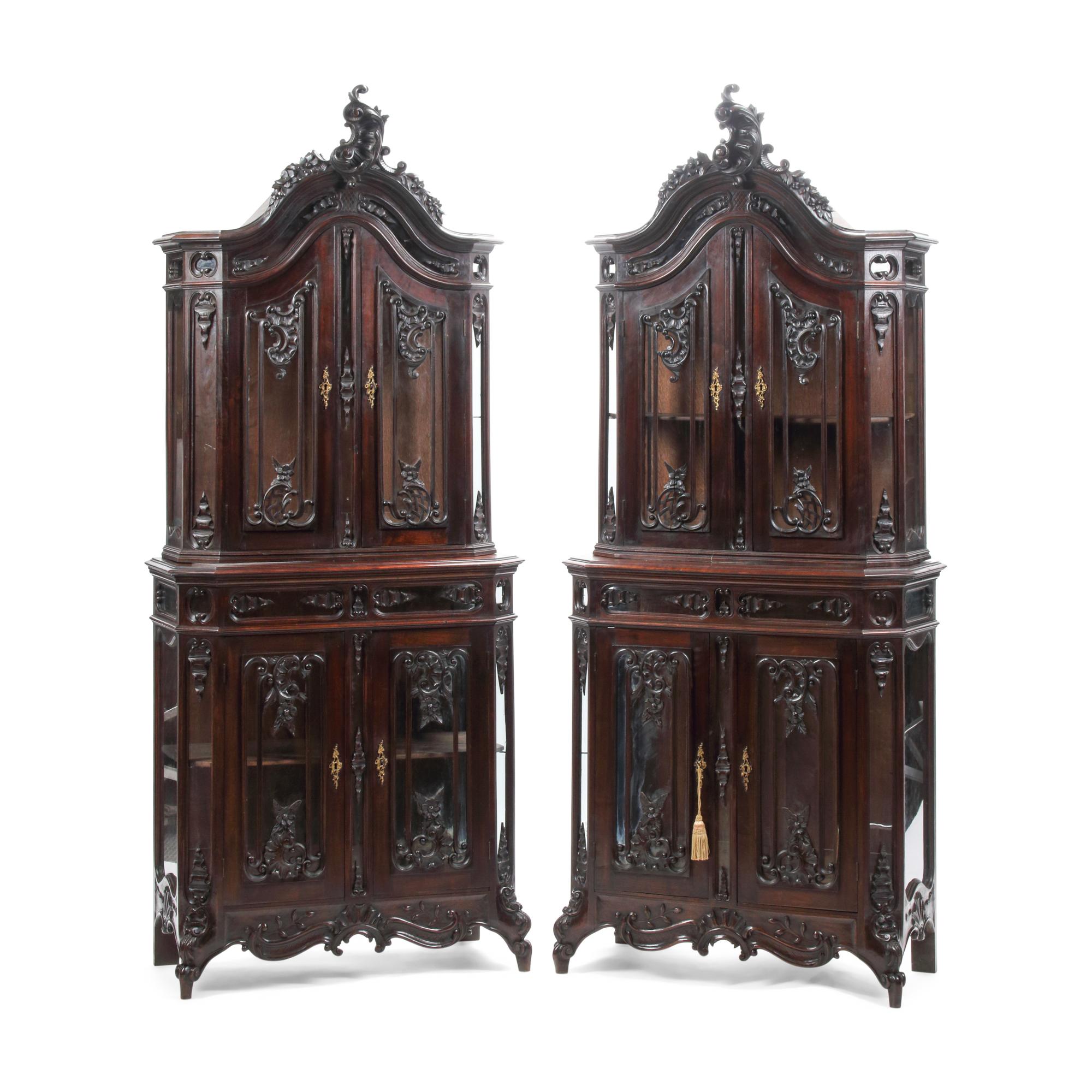 A Pair of Continental Rococo Style Carved Mahogany Vitrine Cabinets
