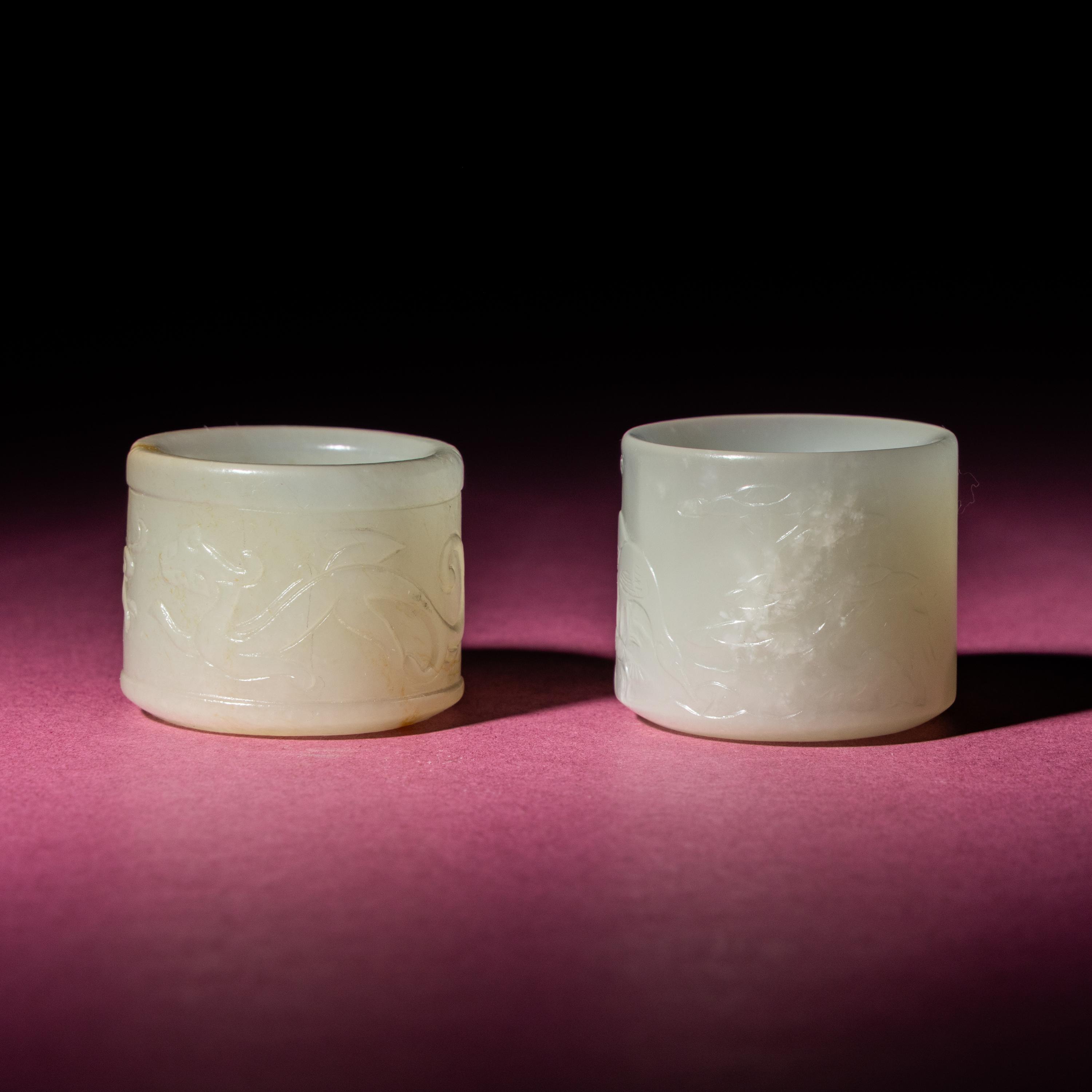 Two Chinese White Jade 'Animal' Archer's Rings, 18th Century — 清中期 白玉刻動物紋扳指兩枚
