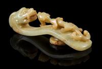 A Carved Celadon and Russet Jade Belt Hook Length 4 1/4 inches. — 18TH/19TH CENTURY