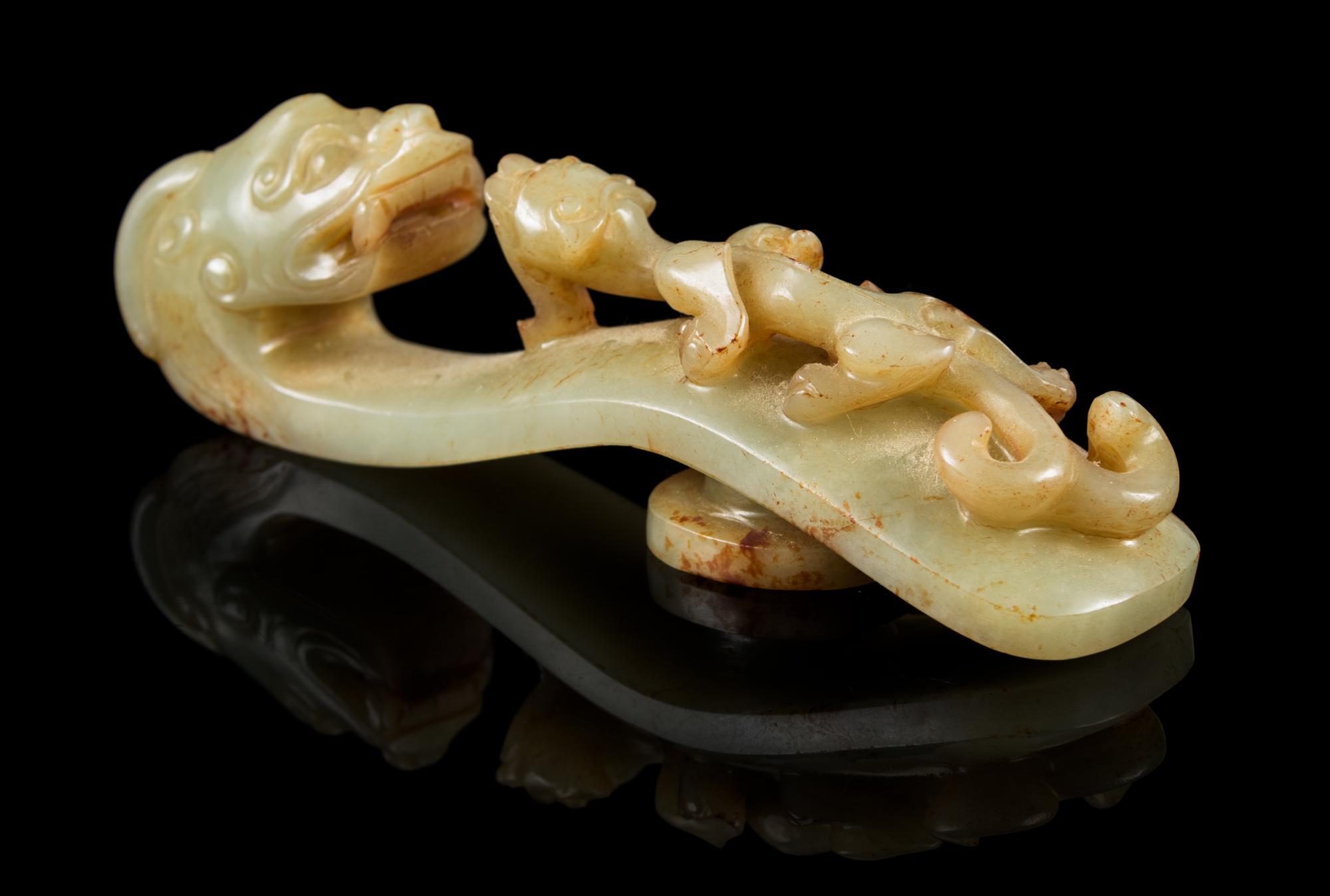 A Carved Celadon and Russet Jade Belt Hook Length 4 1/4 inches. — 18TH/19TH CENTURY