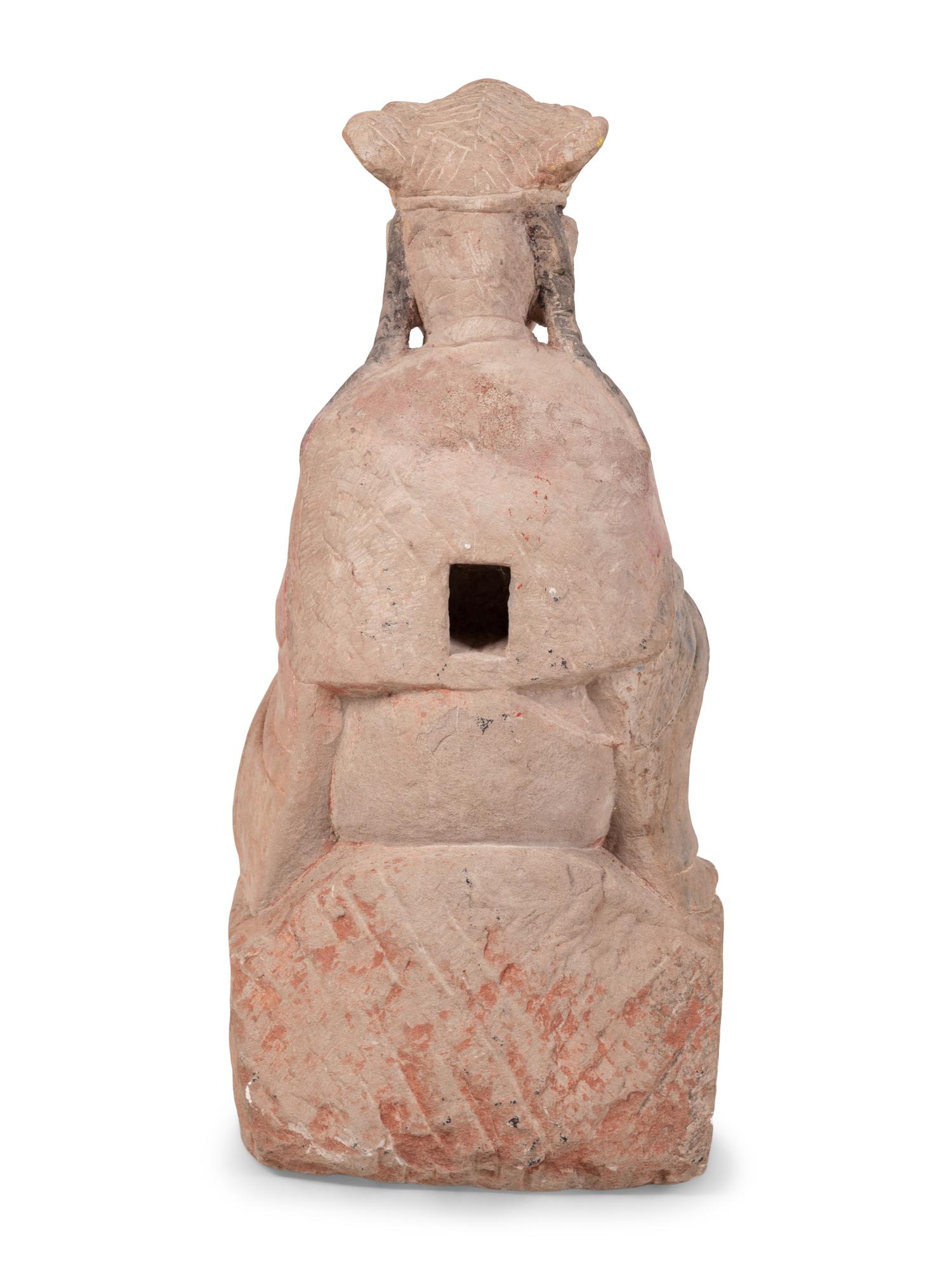 A Chinese Carved Stone Seated Figure with Polychrome Decoration