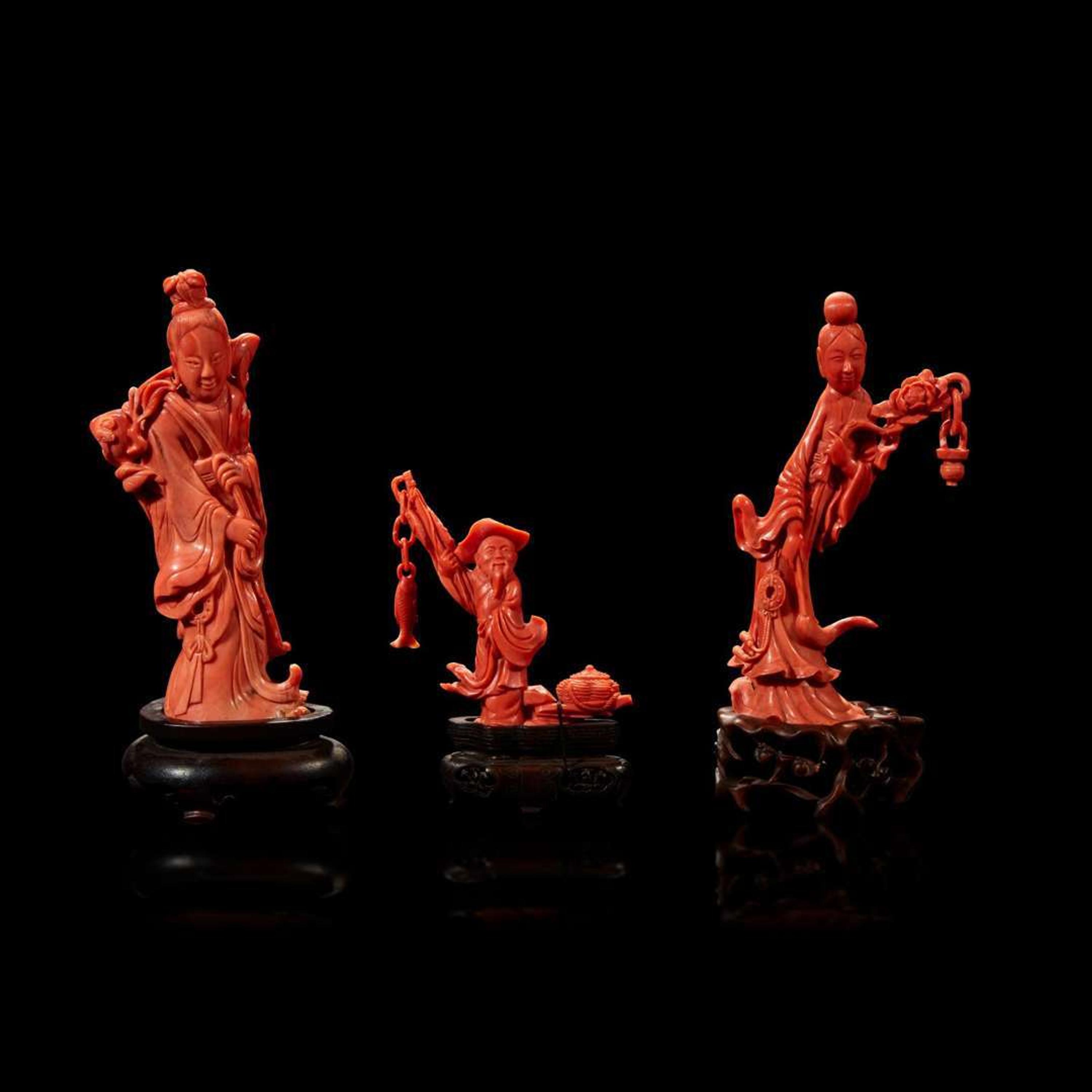Three Chinese carved coral figural groups, meiren and peach, man and basket, meiren and flower