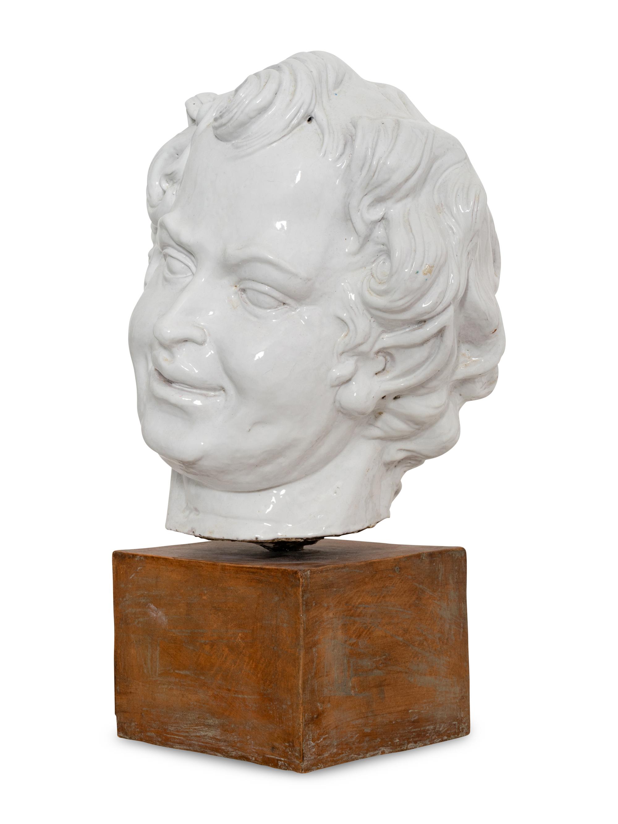 A Large White-Glazed Terracotta Bust on Ceramic Stand
