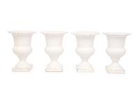 A Set of Four White Glazed Faience Urns