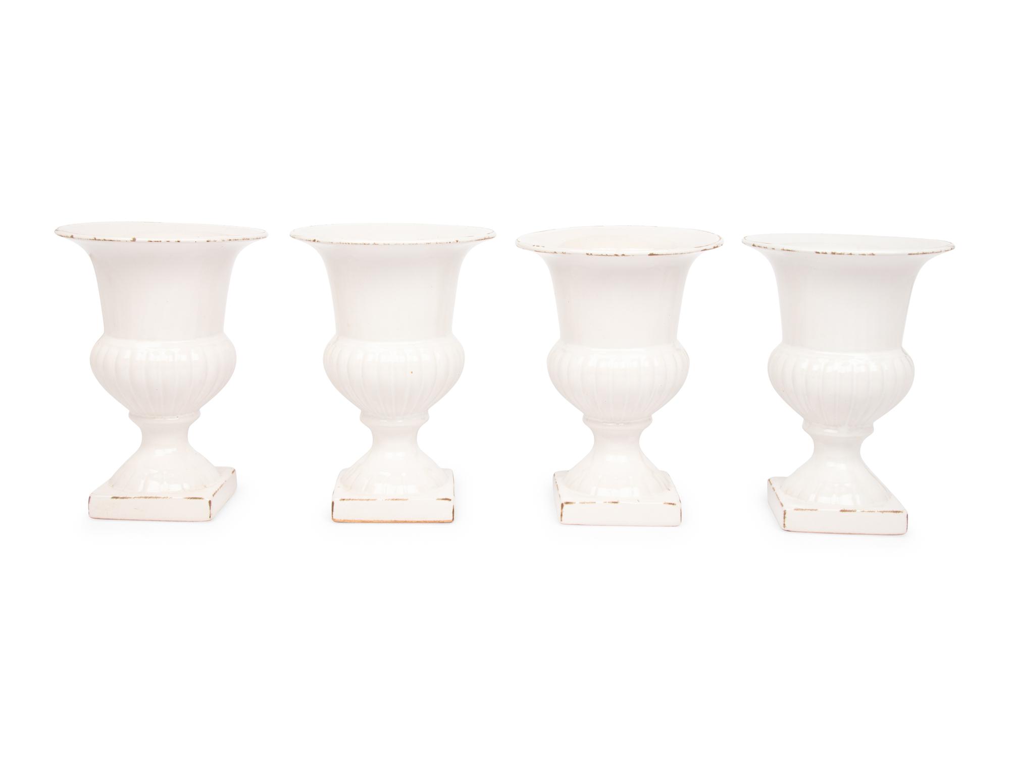A Set of Four White Glazed Faience Urns