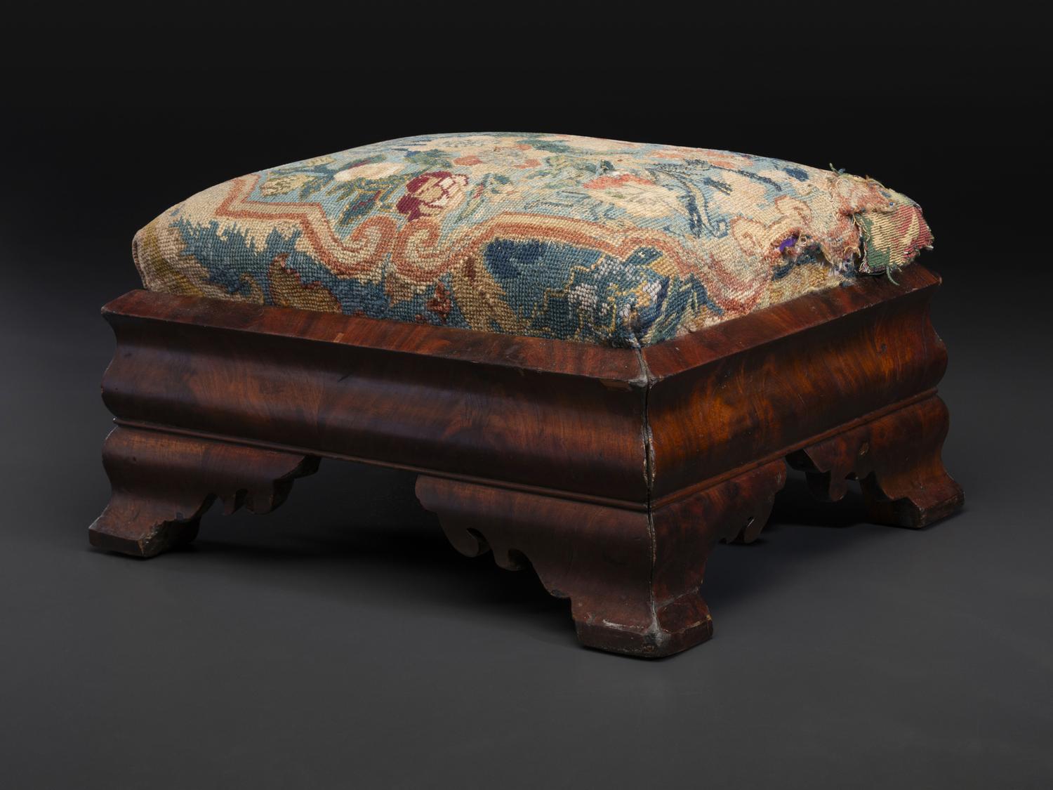 An American Empire Mahogany Veneered and Needlepoint Upholstered Footstool