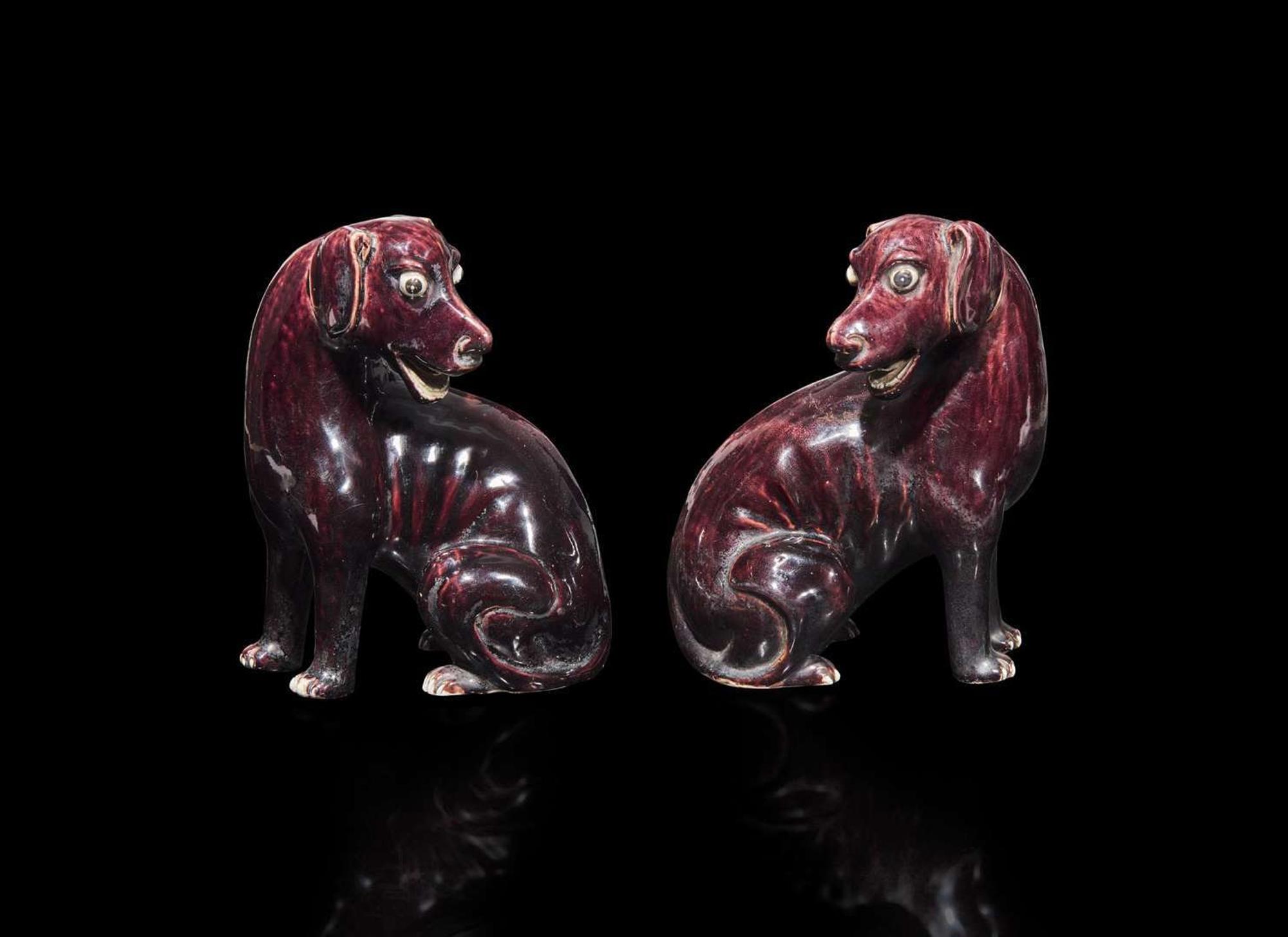 A pair of Chinese export aubergine-glazed porcelain seated dogs, 茄紫釉小狗一對