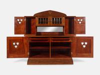 An Austrian Secessionist Inlaid Dining Suite, comprising a sideboard, a server, an extension dining table with five leaves, six side chairs and four armchairs