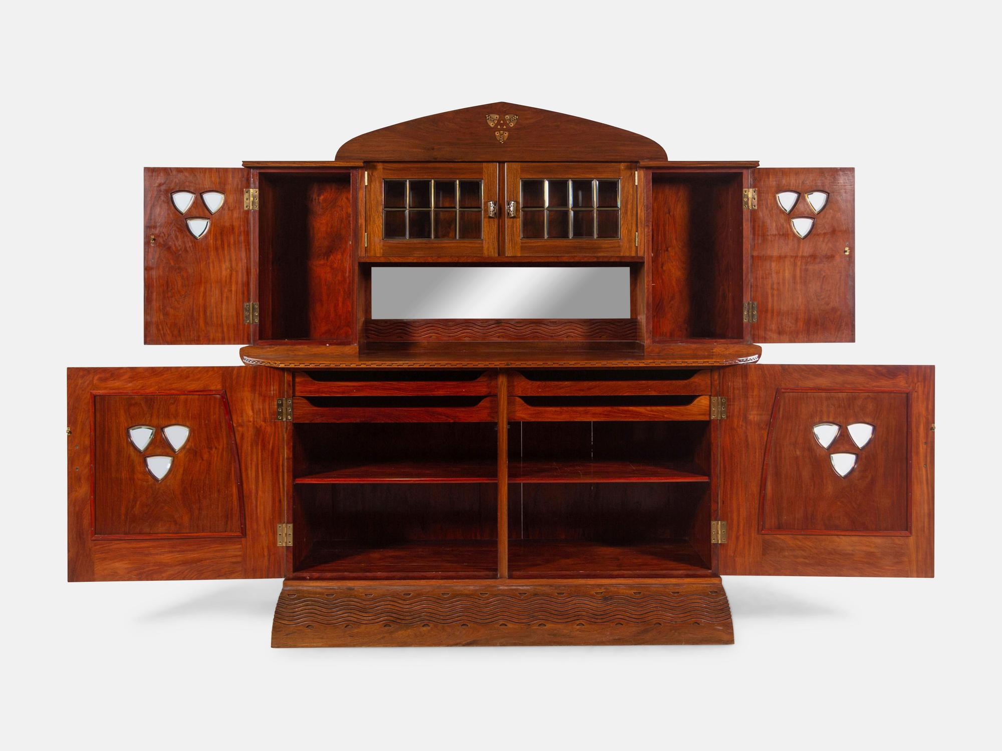An Austrian Secessionist Inlaid Dining Suite, comprising a sideboard, a server, an extension dining table with five leaves, six side chairs and four armchairs