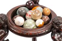 A Continental Carved Wood Jardinière and Fifteen Marble Ornaments