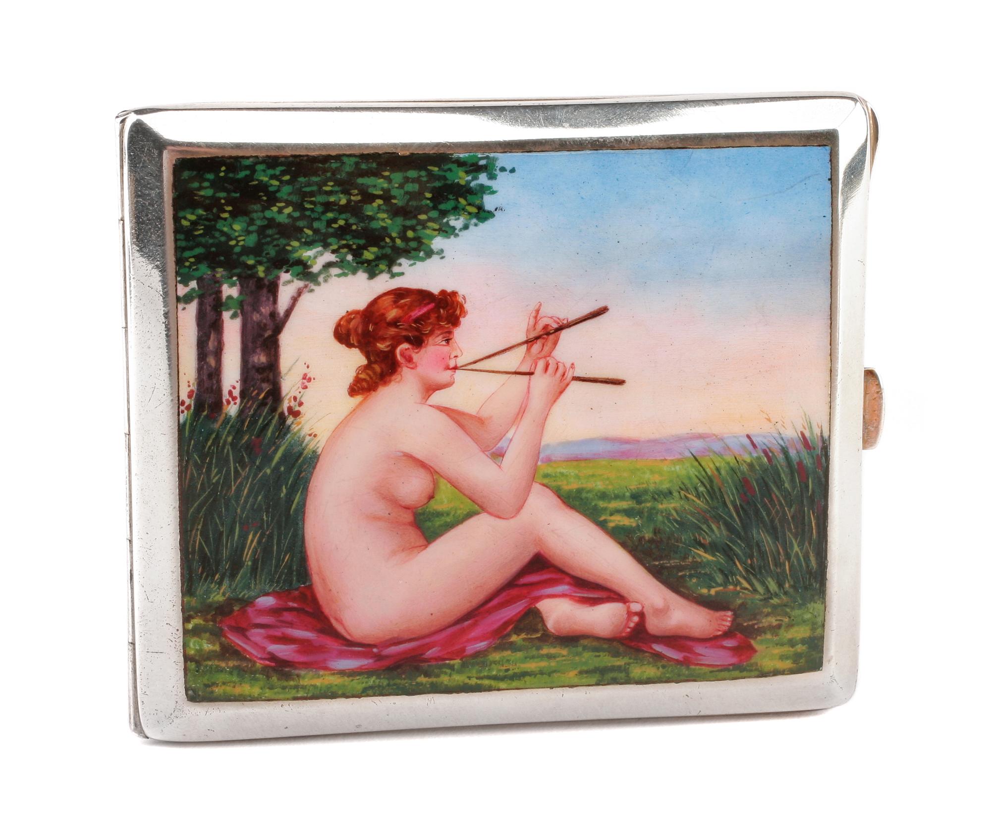 An Enameled Silvered Metal Cigarette Case, Early 20th Century, the lid enameled to show a seated nude playing two flutes in a garden se