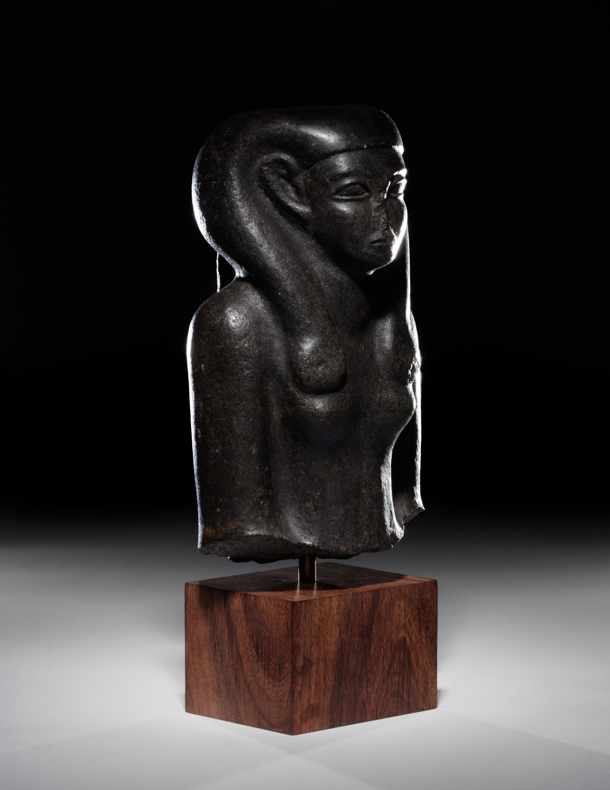An Egyptian Basalt Portrait Bust of a Woman