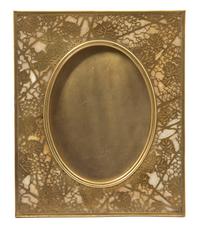 A Tiffany Studios Gilt Bronze Picture Frame 11 5/8 x 9 5/8 inches. — 20TH CENTURY