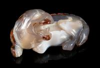 A Chinese Carved Agate Figure of a Recumbent Fu Lion Length 5 1/4 inches. — LATE 19TH/20TH CENTURY