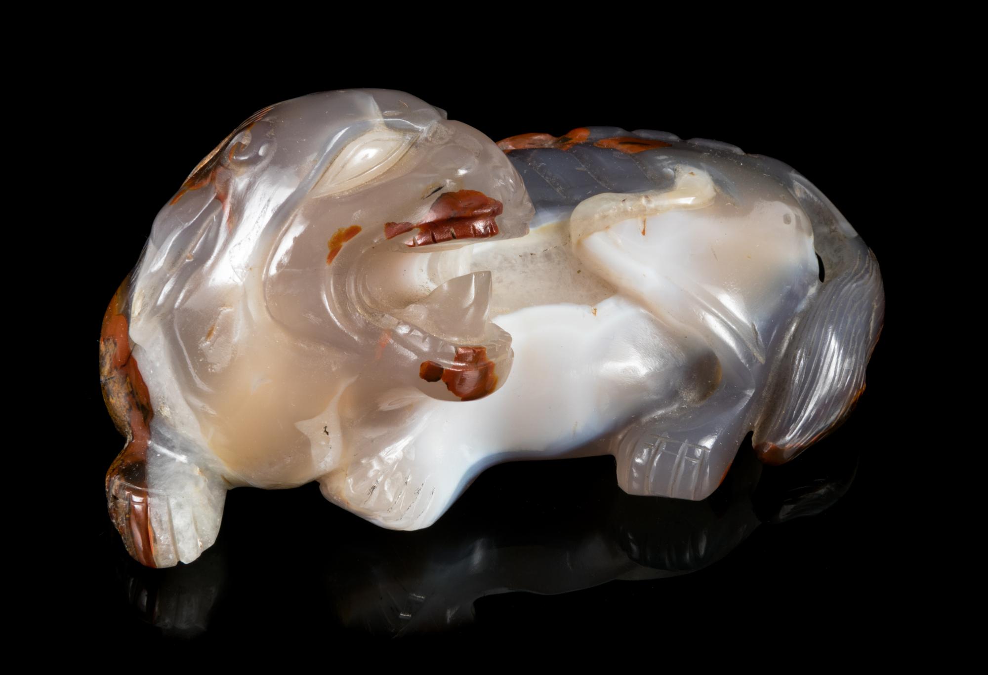 A Chinese Carved Agate Figure of a Recumbent Fu Lion Length 5 1/4 inches. — LATE 19TH/20TH CENTURY