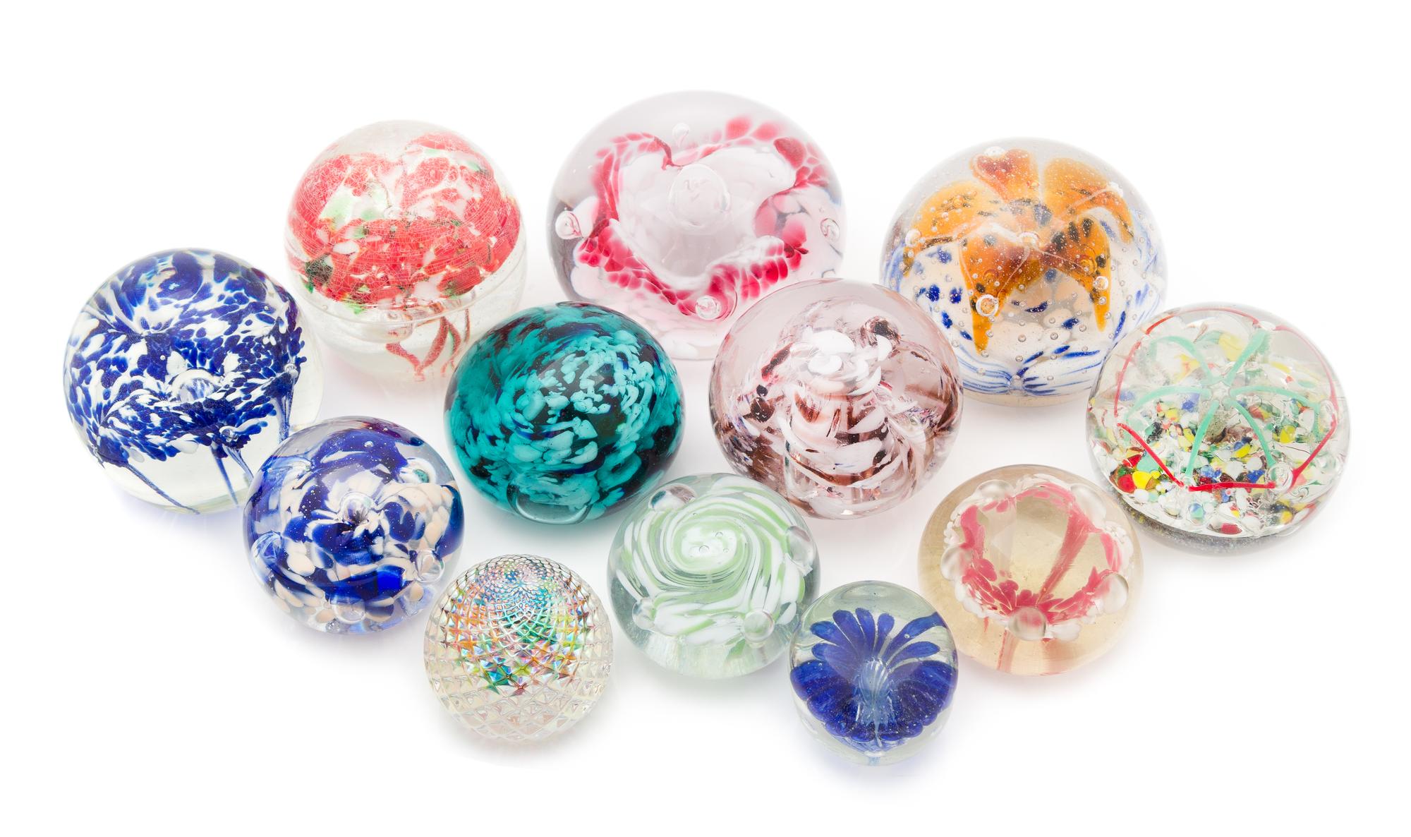 A Collection of Glass Paperweights Diameter of largest 3 1/2 inches