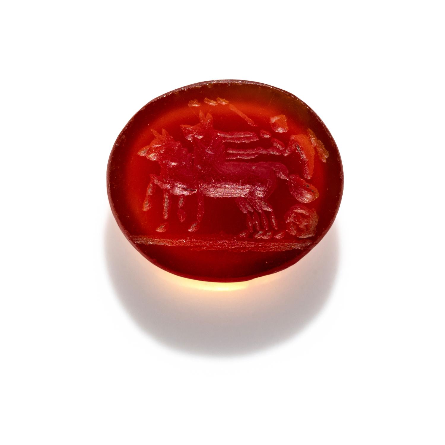 A Roman Carnelian Intaglio with Eros Driving a Biga