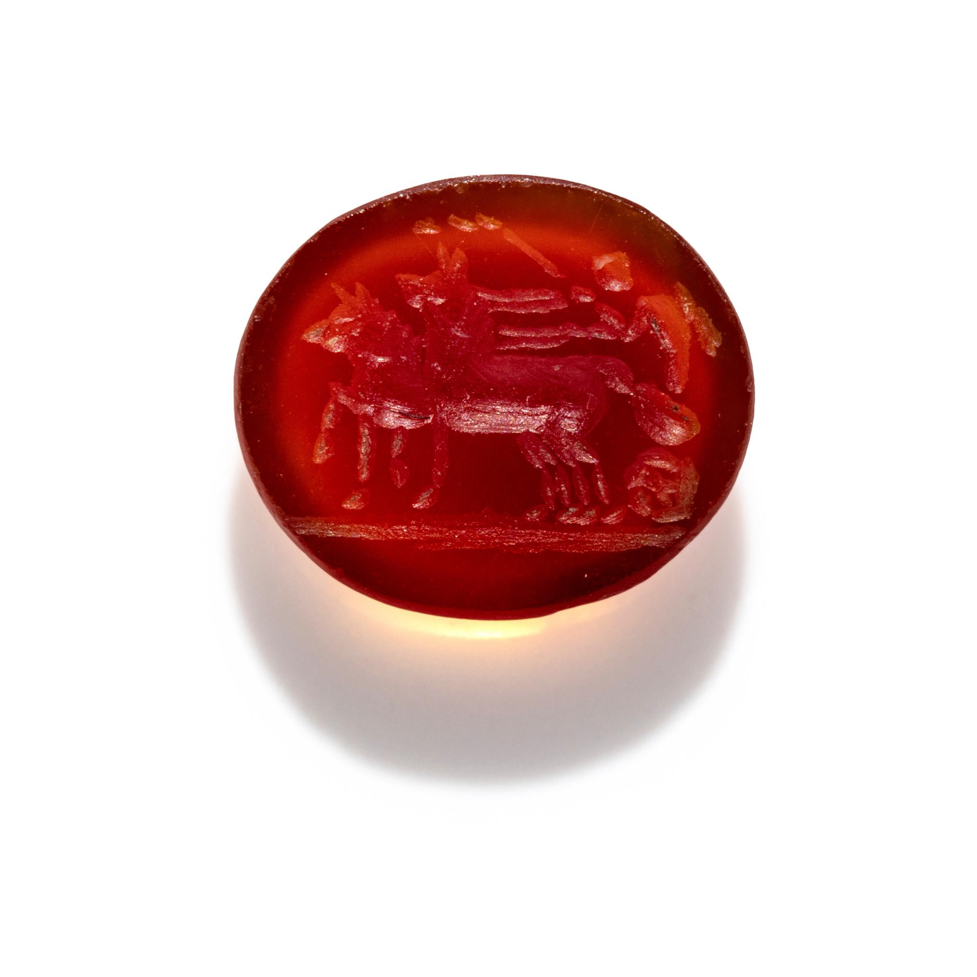 A Roman Carnelian Intaglio with Eros Driving a Biga