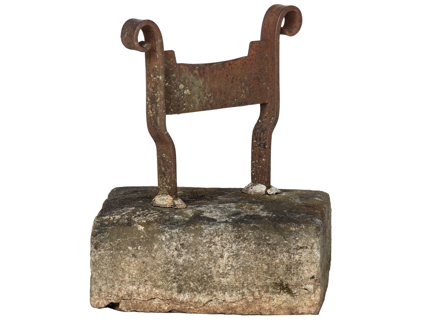 A Wrought Iron Boot Scrape with Stone Base
