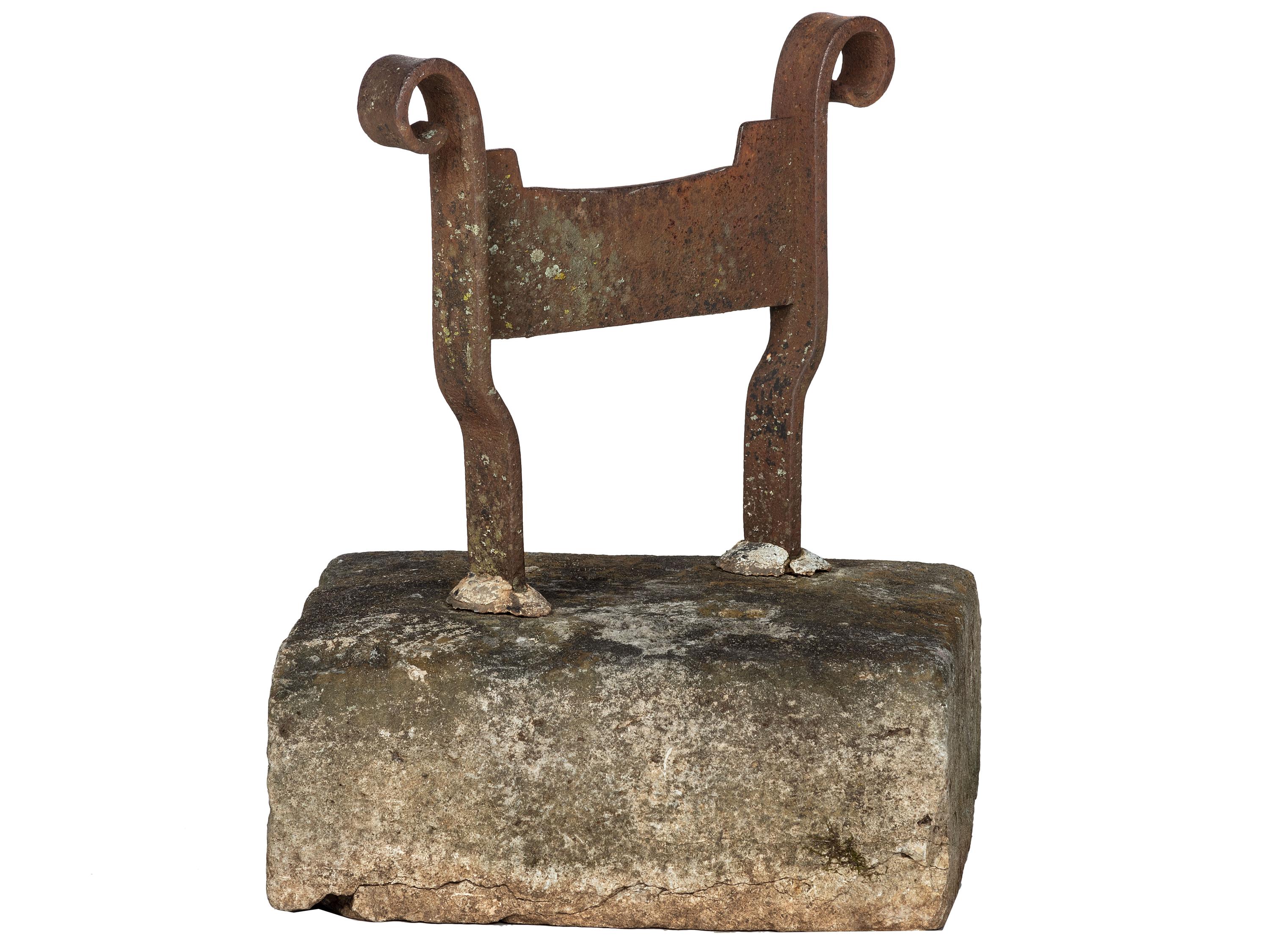 A Wrought Iron Boot Scrape with Stone Base