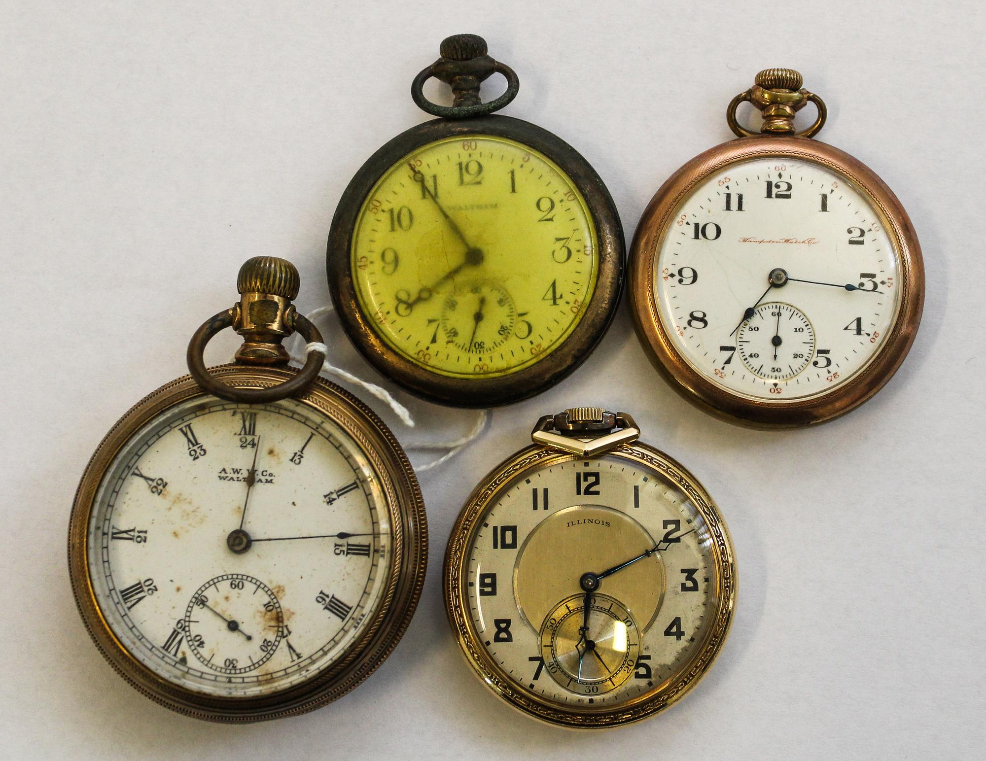 A Collection of Four Pocket Watches Height of largest 3 1/8 inches.