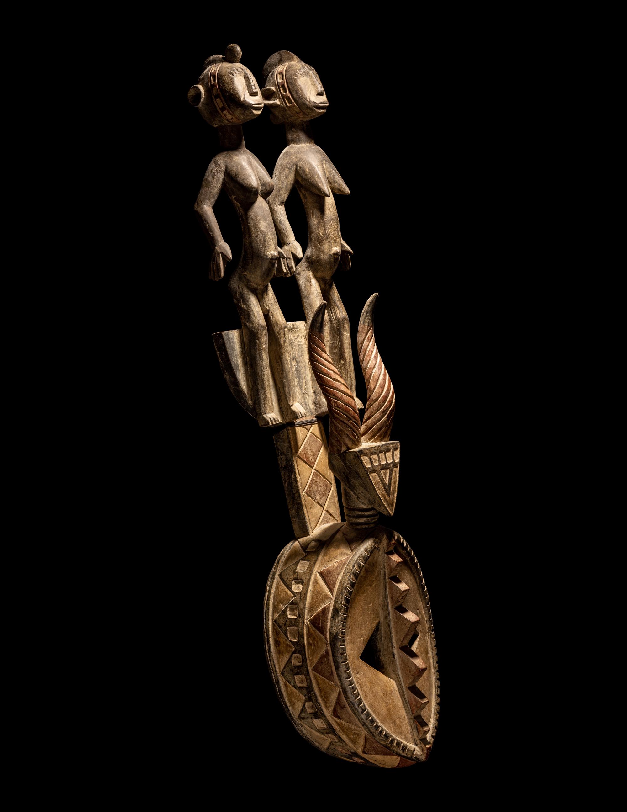 A Bamana Wood Horned Mask with Figures