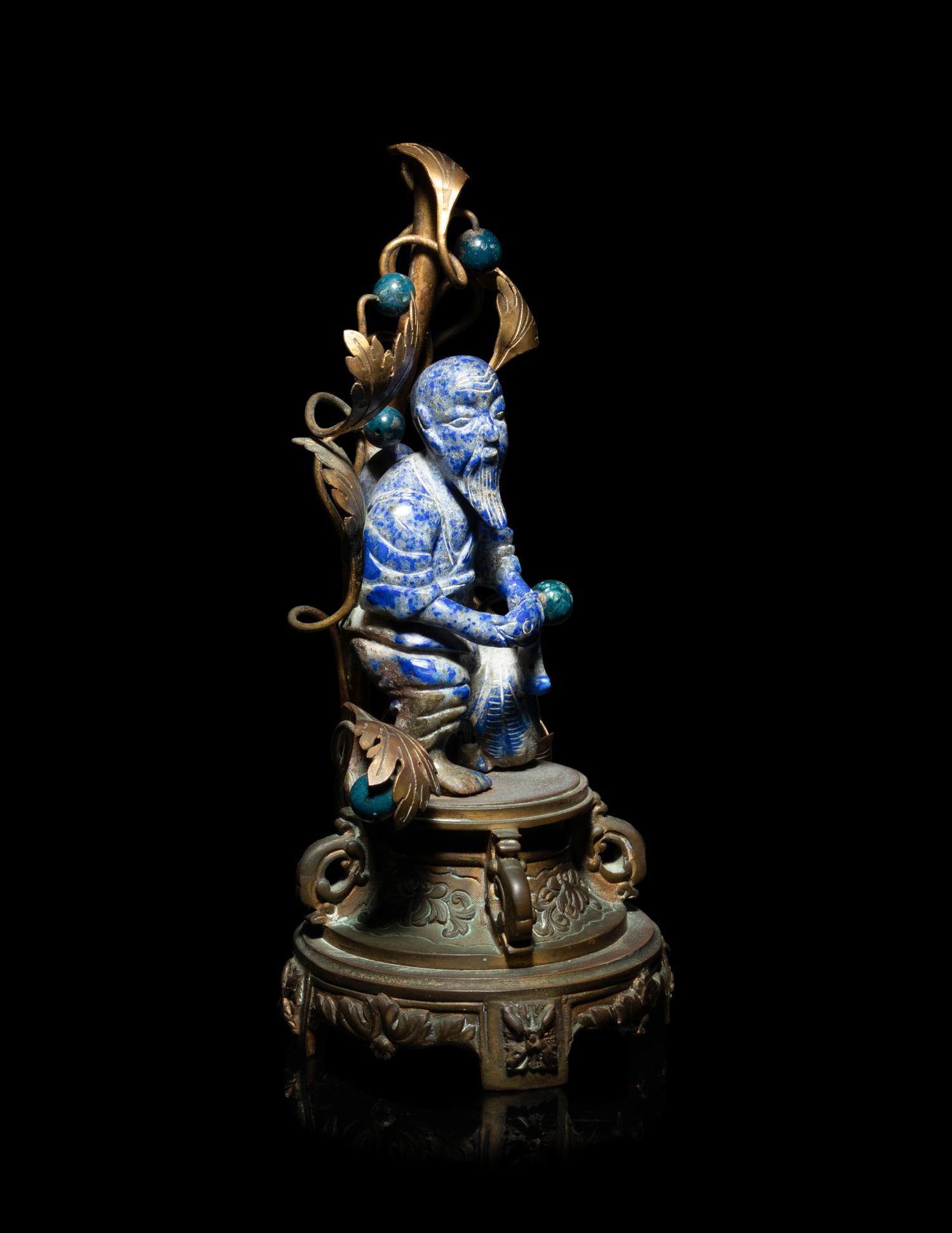 A Chinese Carved Lapis Lazuli Figure of a Fisherman
