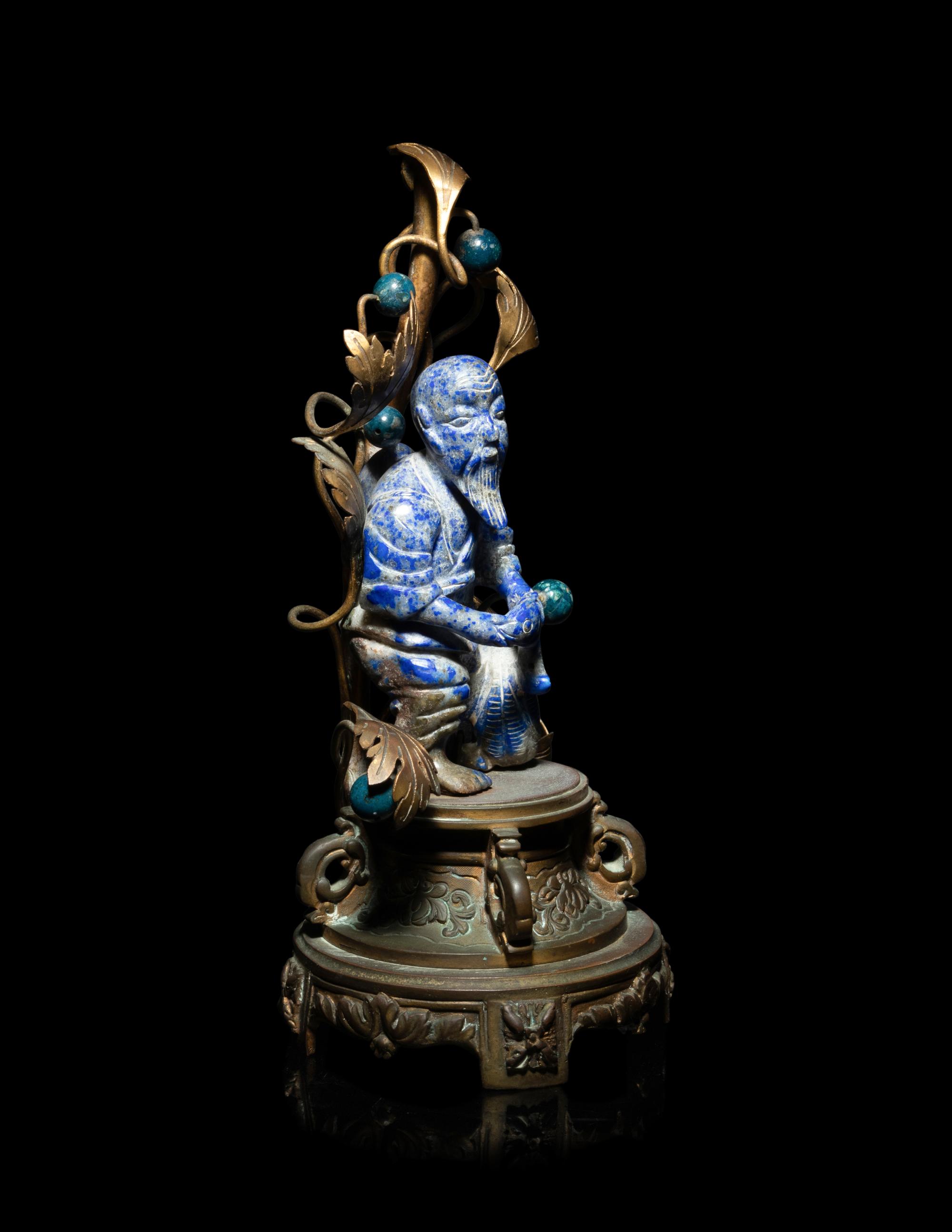 A Chinese Carved Lapis Lazuli Figure of a Fisherman