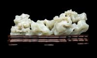 A Chinese Pale Celadon Jade ‘Lingzhi and Rockwork’ Brush Rest, 20th Century — 近代 青白玉靈芝筆架