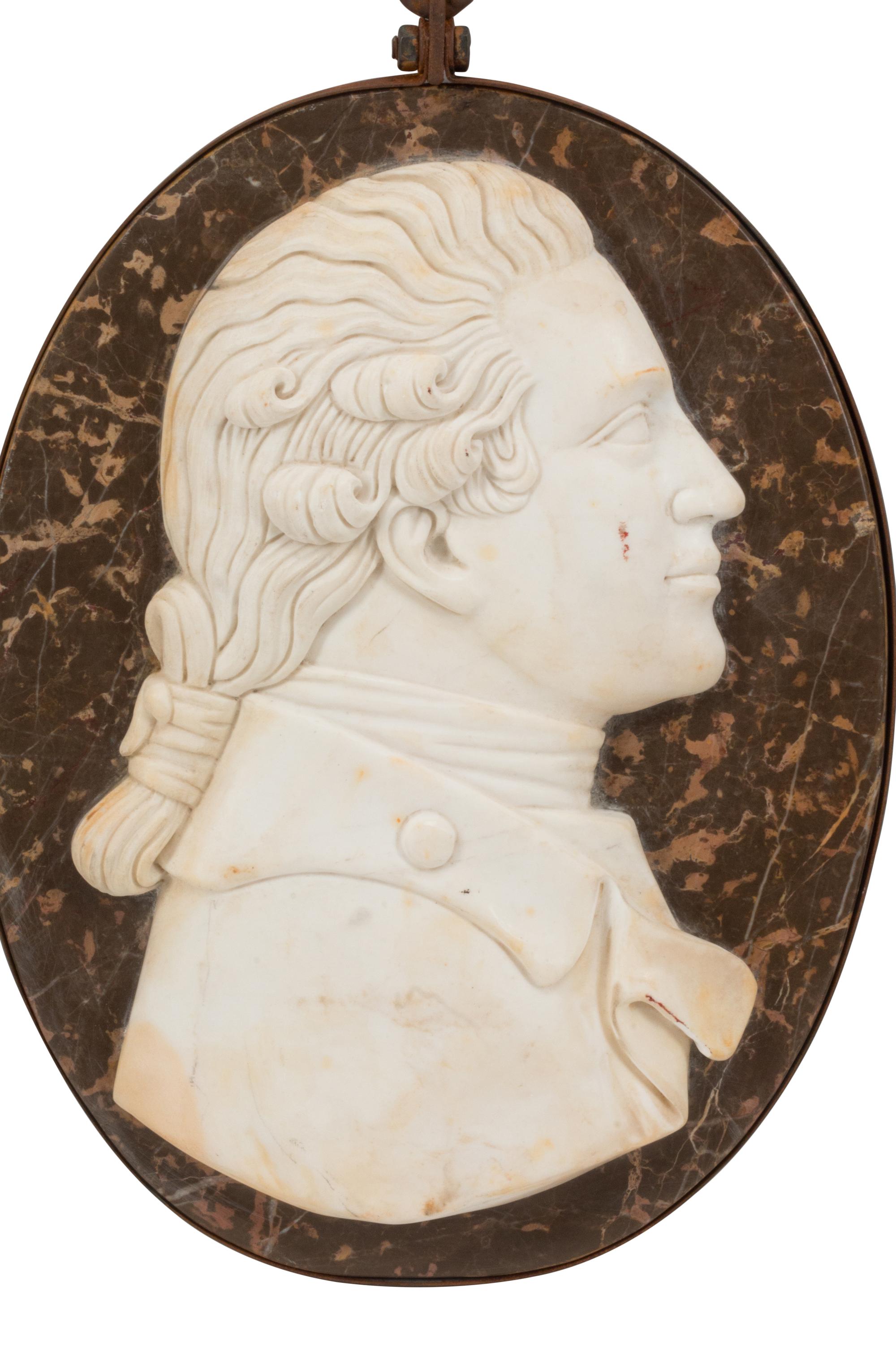 A Set of Four Italian Carved Marble and Iron Mounted Profile Medallions
