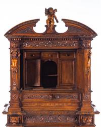 A Renaissance Revival Carved Walnut Cabinet on Stand