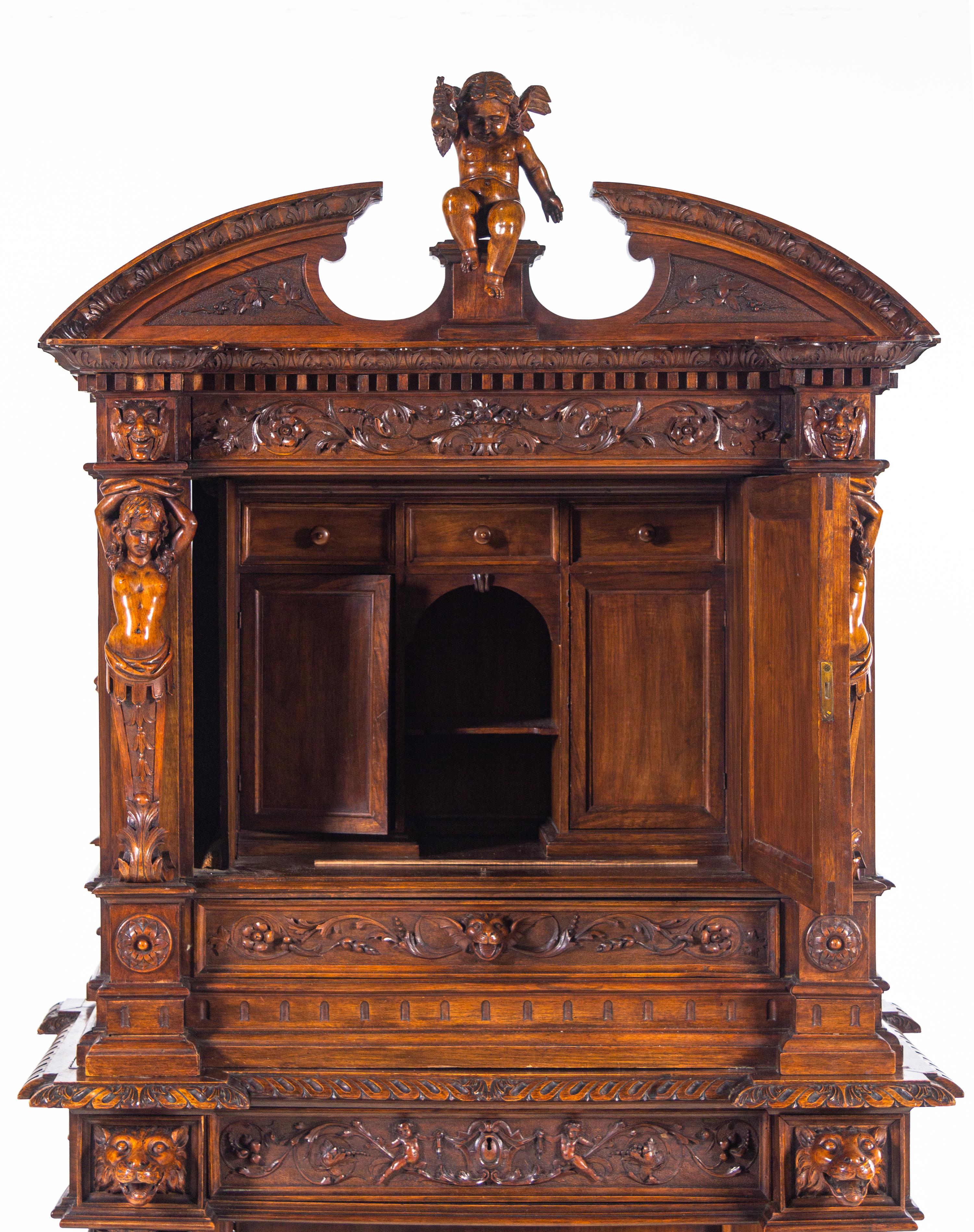 A Renaissance Revival Carved Walnut Cabinet on Stand