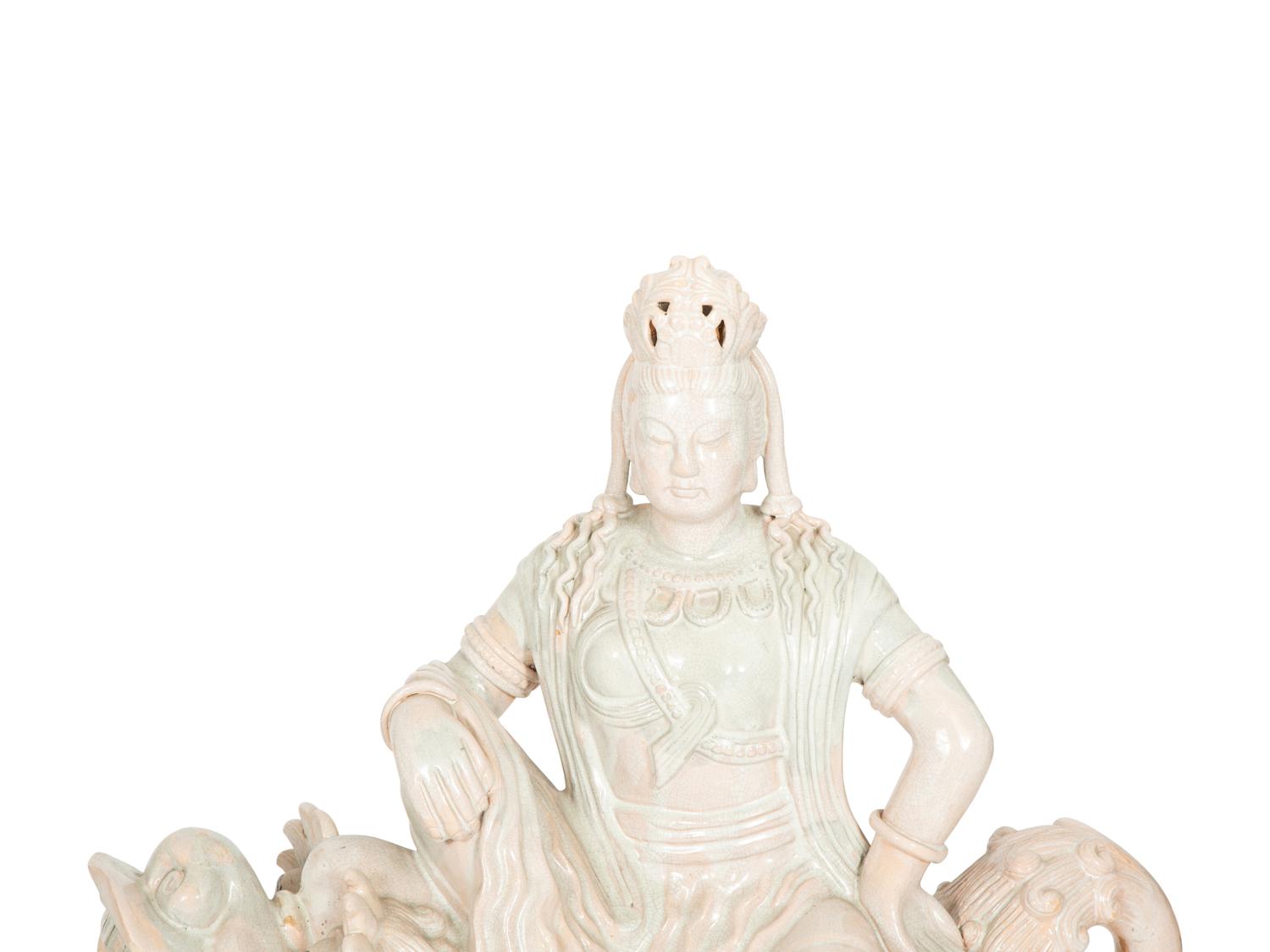 A Pair of Chinese Glazed Ceramic Figures of Guan Yin Atop a Foo Dog