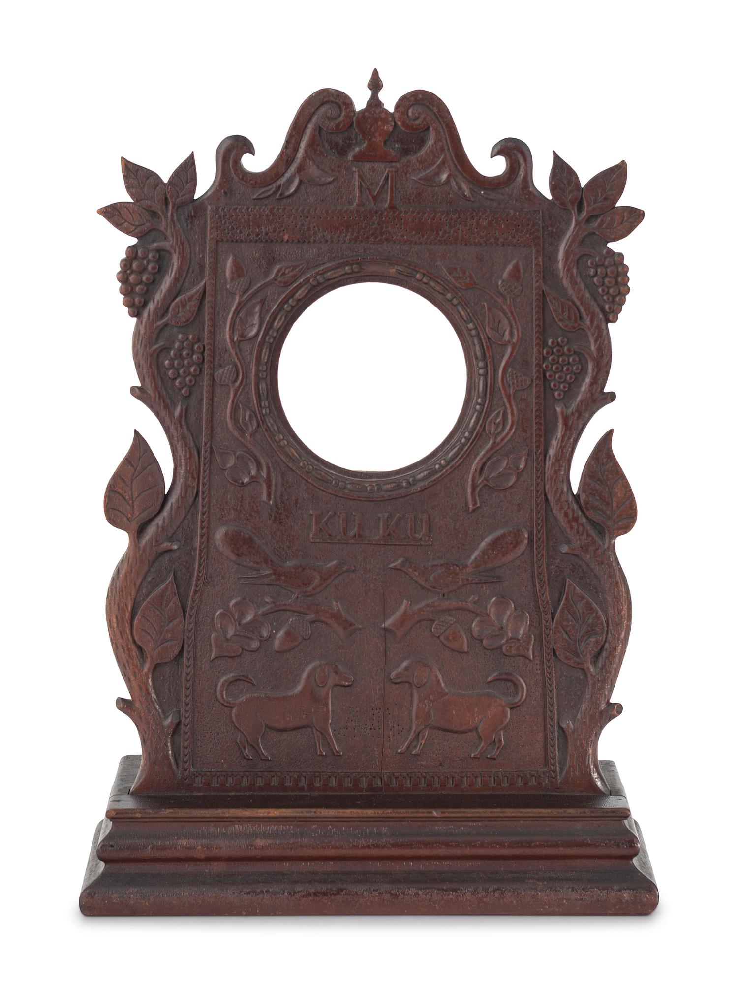 A Carved Walnut Folk Art Clock Hutch