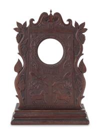 A Carved Walnut Folk Art Clock Hutch