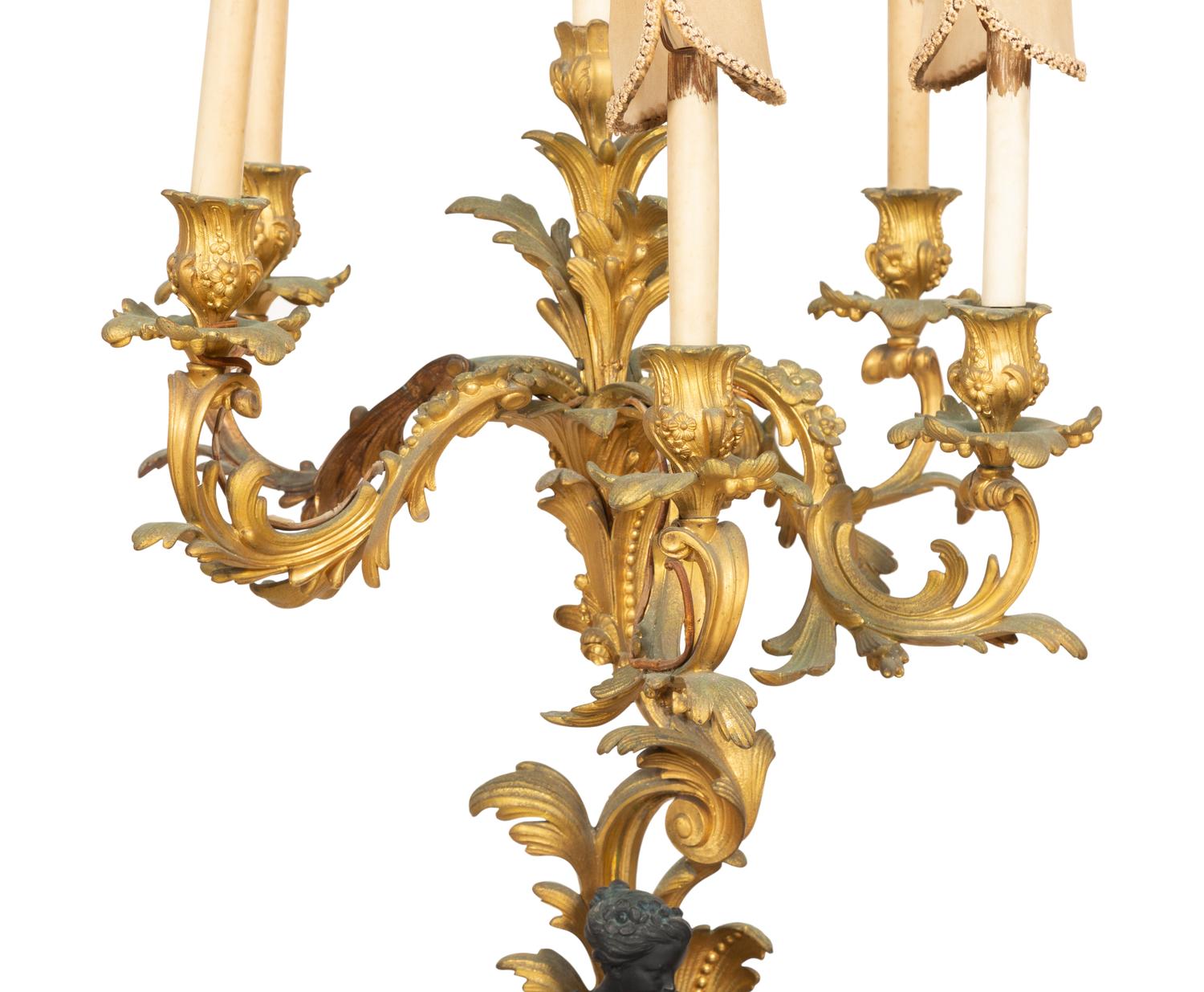 A Pair of Louis XV Style Gilt and Patinated Bronze Figural Six-Light Candelabra