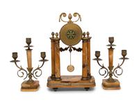 A French Gilt Metal and Siena Marble Three-Piece Clock Garniture