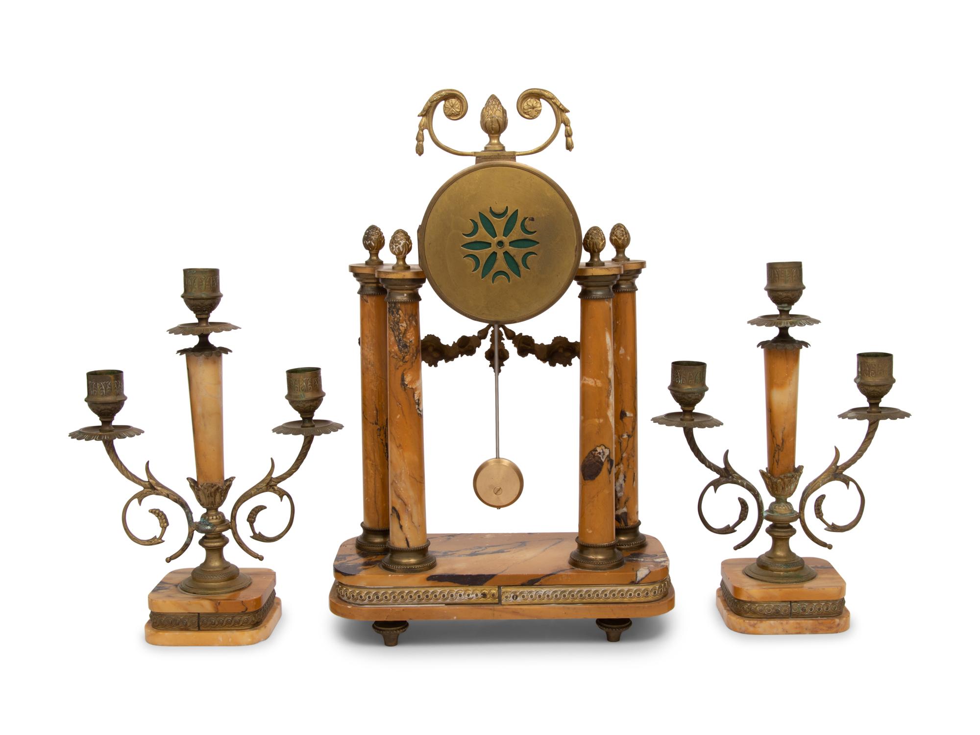 A French Gilt Metal and Siena Marble Three-Piece Clock Garniture