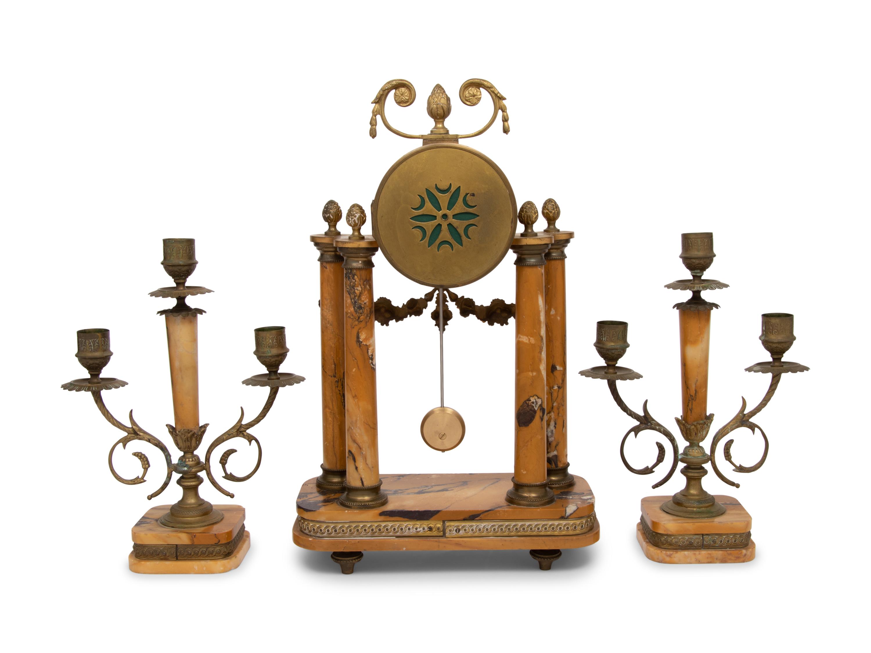 A French Gilt Metal and Siena Marble Three-Piece Clock Garniture